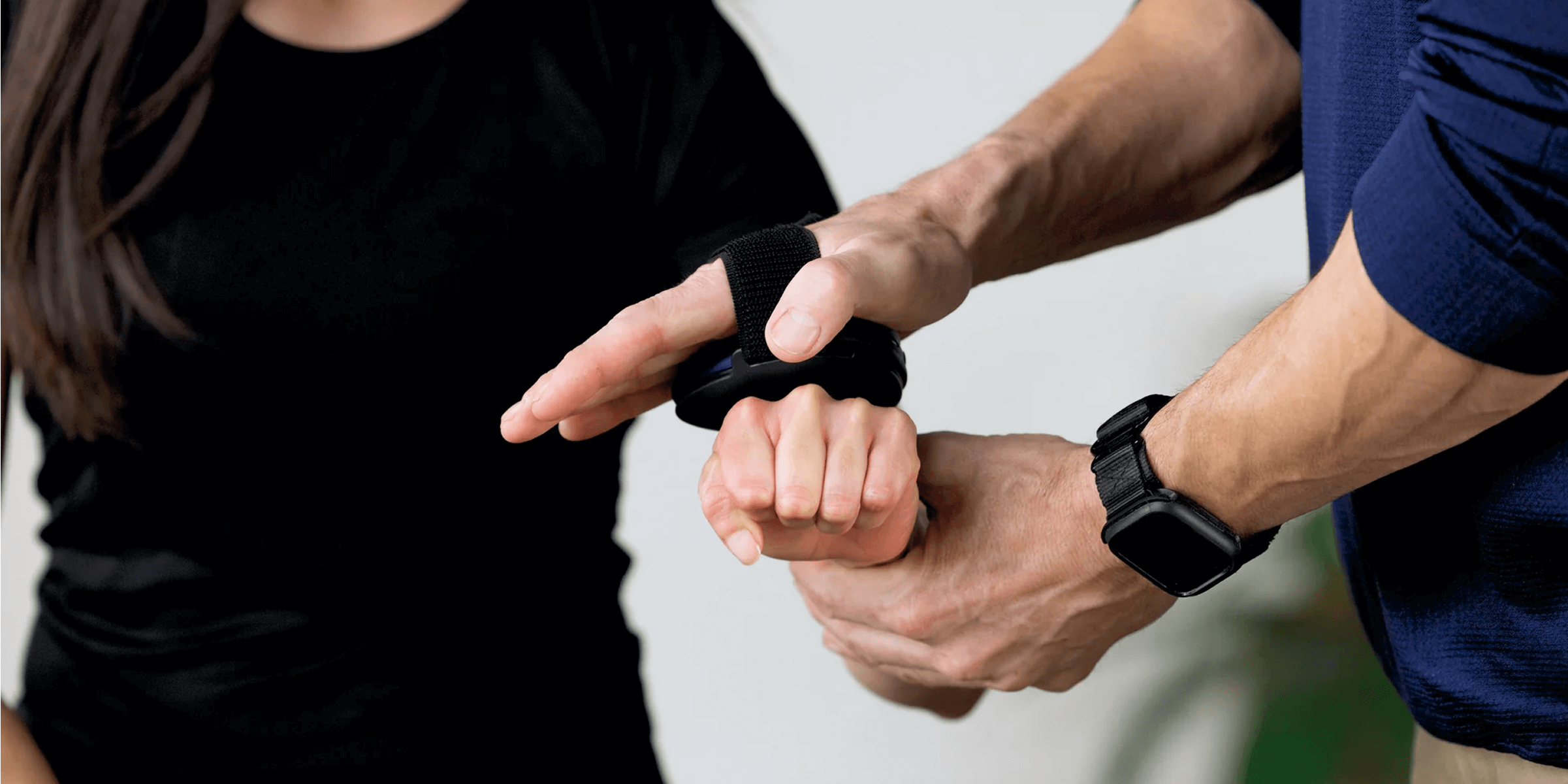 Clinician measuring wrist strength with ActivForce